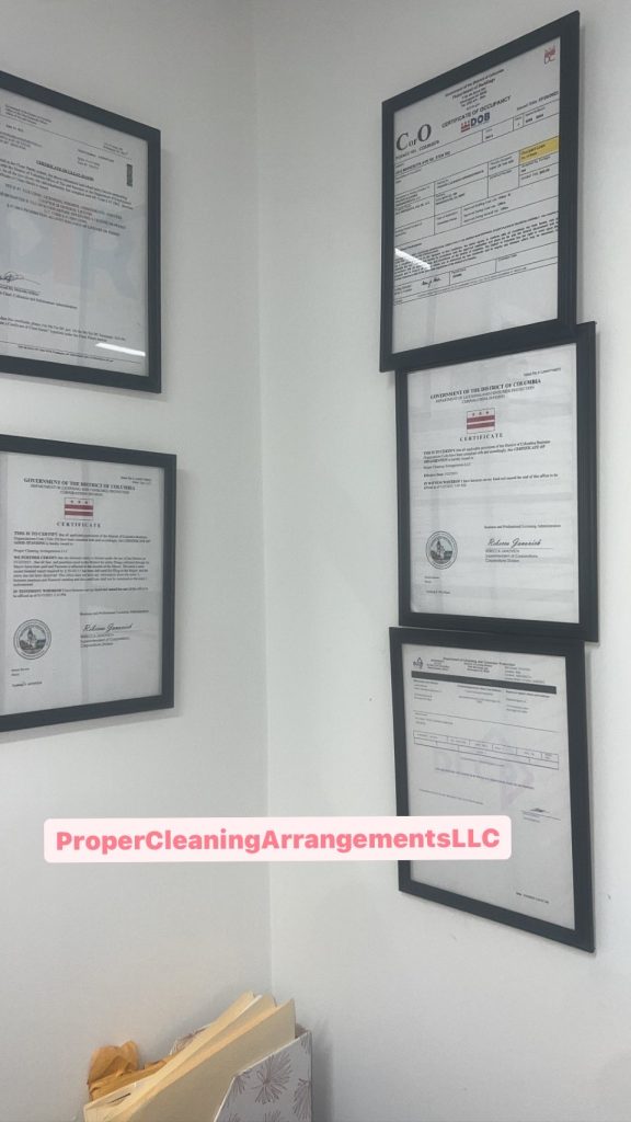 Certificates and documents framed on white wall